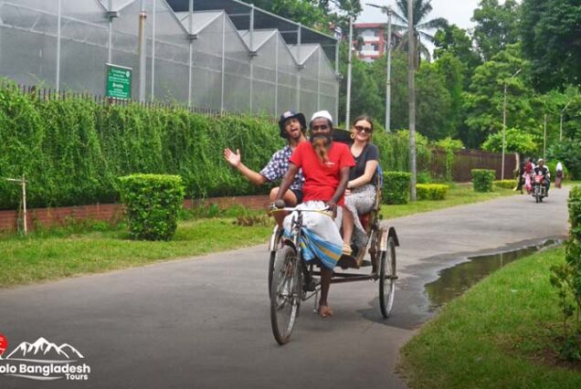 Two tourists on a rickshaw ride during old dhaka tour like a local